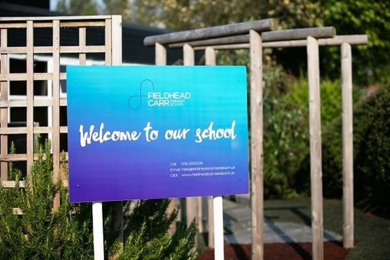 An image of a Welcome to Our School post and panel sign.